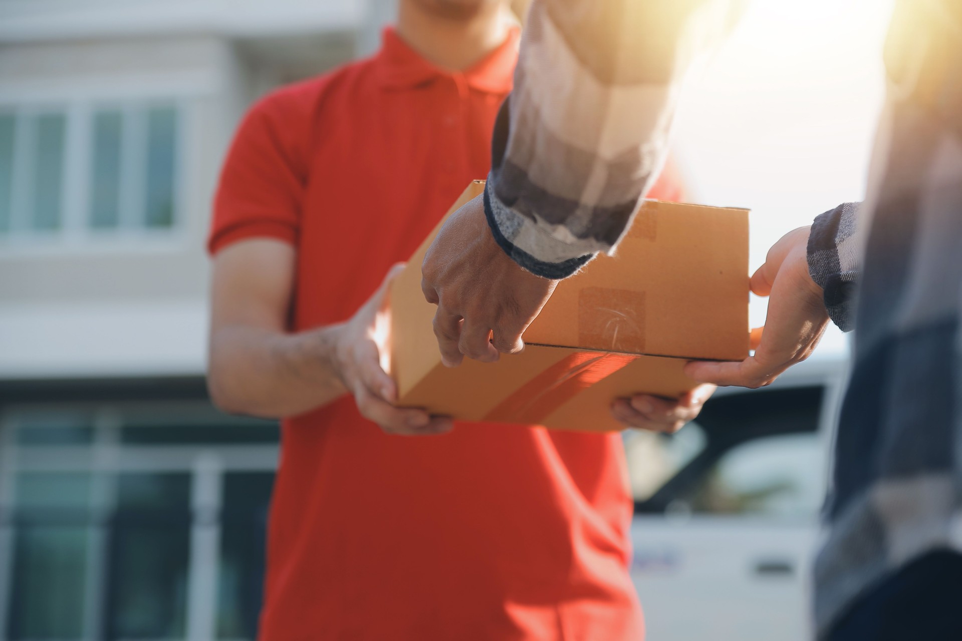 Asian delivery express courier young man use giving boxes to woman customer he wearing protective face mask at front home